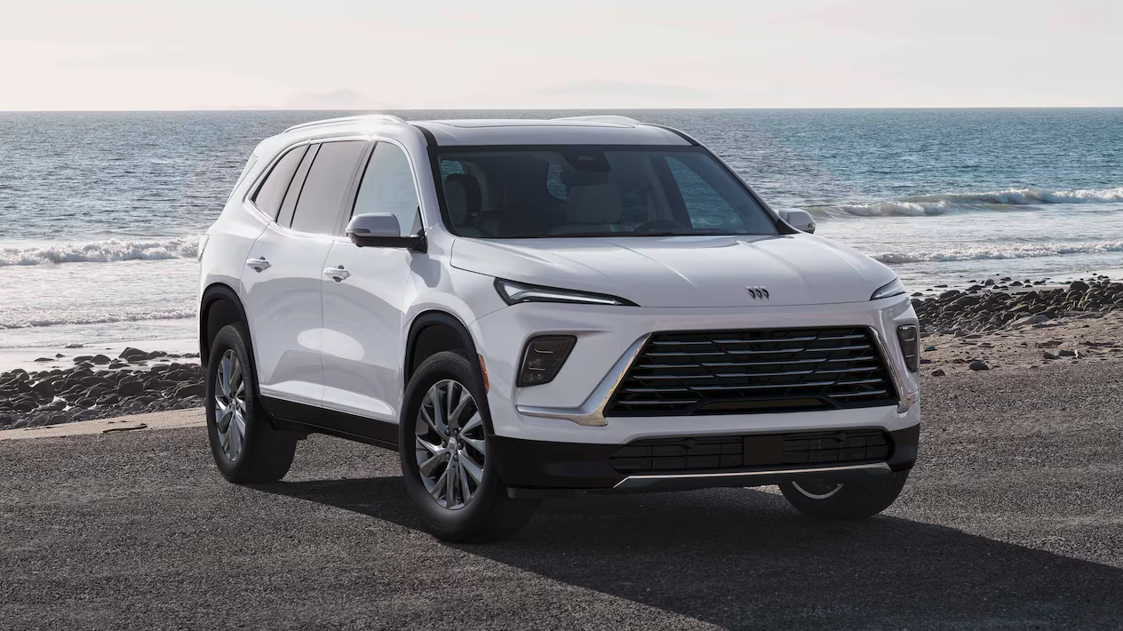 Front and side view of the 2026 Buick Enclave parked by a body of water