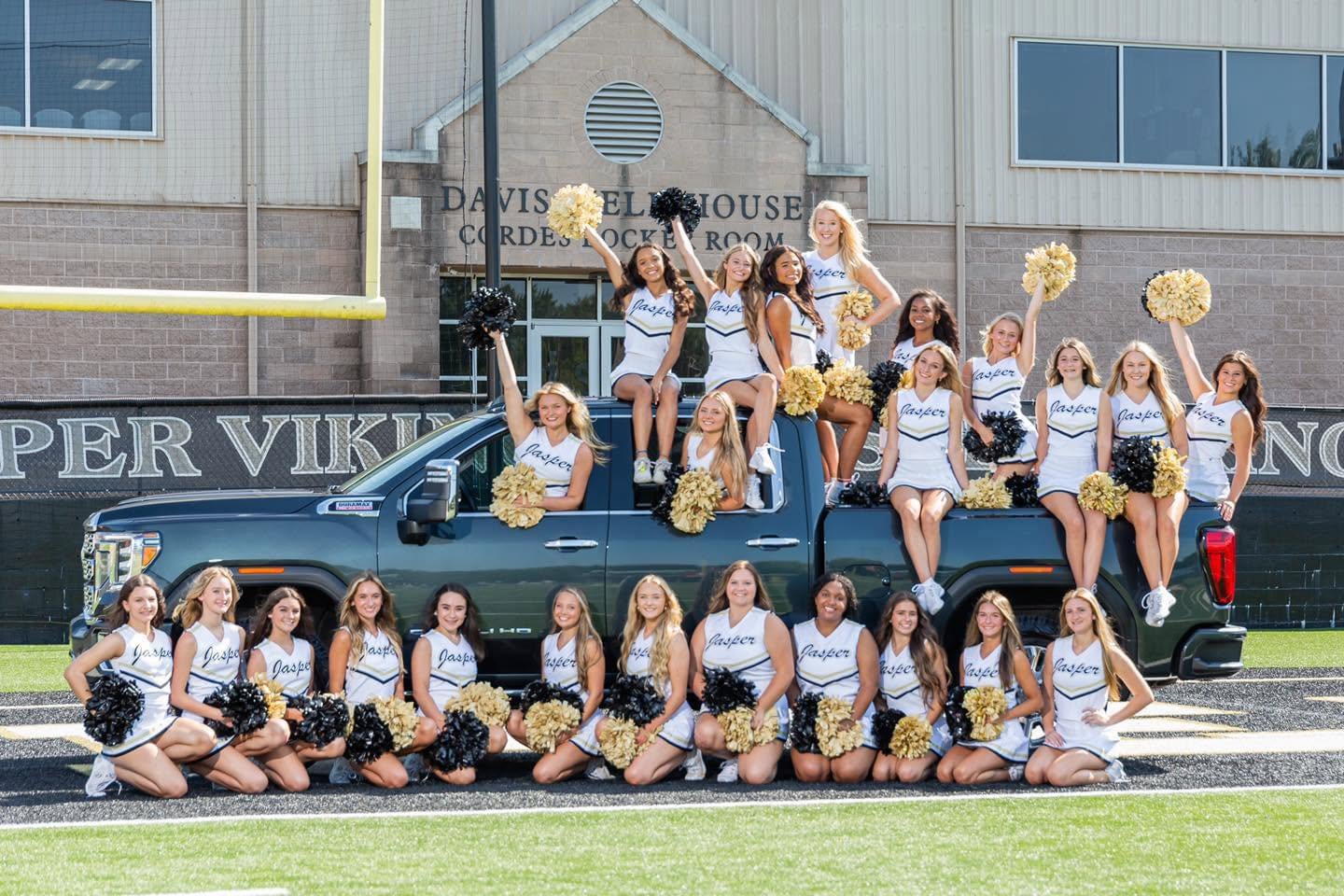 Jasper High School cheerleaders in a Chevrolet pickup truck
