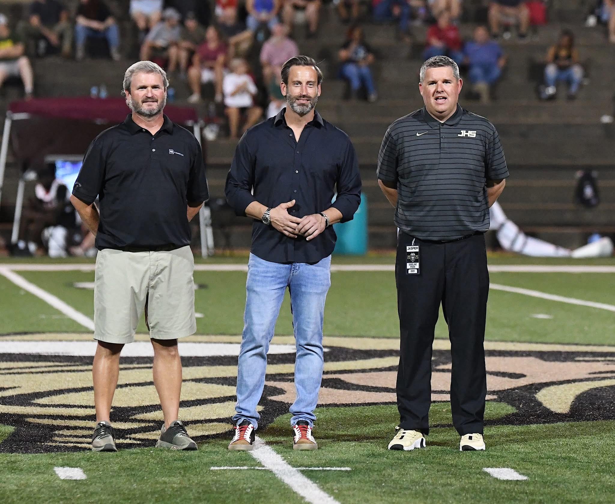 Curt Ballard, Dealer Operator and JHS Athletic Director Coach Jordan with Jasper Mayor Josh Gates on a football field
