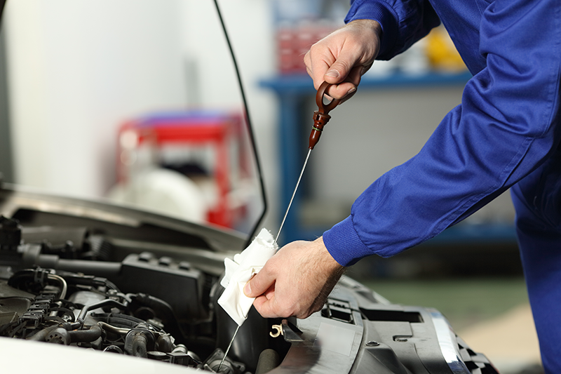 Technician Checking Oil
